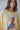 Close-up of the Syrat Sweater highlighting the colorful embroidered bird design, ultra-soft knit texture, and relaxed crew neckline.