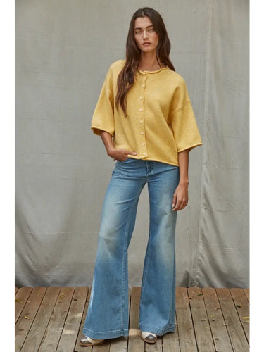 Talina lightweight mustard yellow knit cardigan featuring rolled-edge trim, elbow-length sleeves, and a relaxed fit, shown from the front.