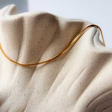 Tiny gold plated chain necklace by Matte, minimalist fine chain on neutral fabric