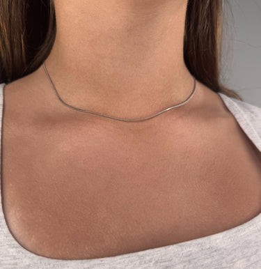 Model wearing Tiny silver chain necklace by Matte, delicate minimalist style