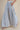 Side view of blue and white striped palazzo pants highlighting the relaxed wide-leg silhouette and flowing fabric.
