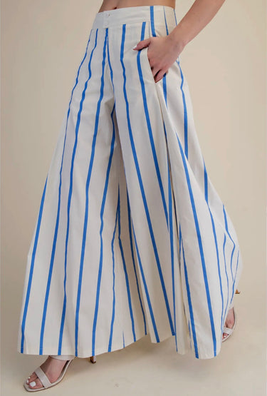 Side view of blue and white striped palazzo pants highlighting the relaxed wide-leg silhouette and flowing fabric.