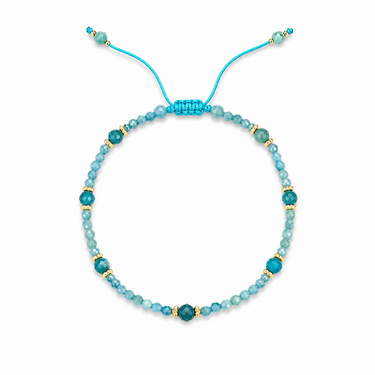 Tral Bracelet adjustable turquoise faceted beaded bracelet with gold-tone accents on neutral background.