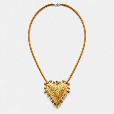 Tria Necklace featuring a textured gold heart pendant on a sleek golden cord necklace against a white background.