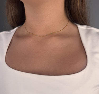 Model wearing Trix gold plated chain necklace by Matte, minimalist beaded jewelry
