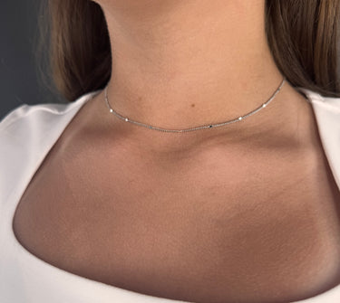 Model wearing Trix silver chain necklace by Matte, delicate minimalist jewelry