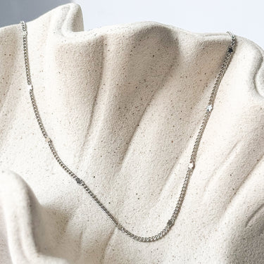 Trix silver gold plated chain necklace by Matte, delicate beaded chain on neutral fabric
