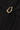 Close-up of the Vania Dress in black showing the fabric and sculptural gold-tone buckle detail.