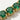 Close-up detail of the green simulated diamond settings.