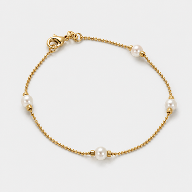 Veru Bracelet featuring luminous pearl accents on a delicate gold chain bracelet with elegant minimalist styling.