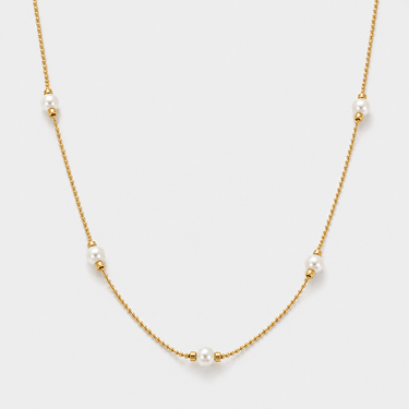Veru Necklace featuring luminous pearl accents spaced along a delicate gold chain with adjustable extender.