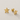Vira Stud Earrings by Matte in polished gold featuring minimalist star-shaped studs with post backs, displayed on a soft textured neutral background.
