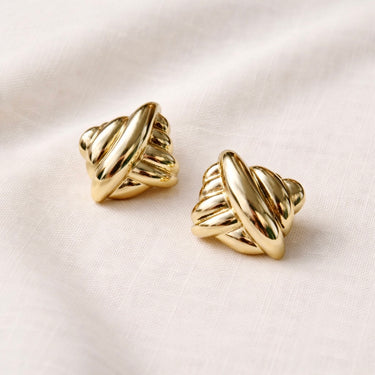 Vire Stud Earrings flat lay image highlighting organic shape and gold finish.