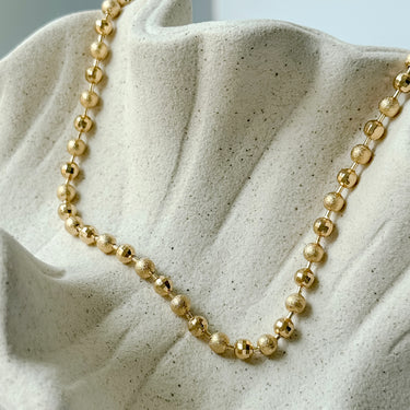 Warren Necklace by Matte, gold filled beaded ball chain on neutral ceramic background