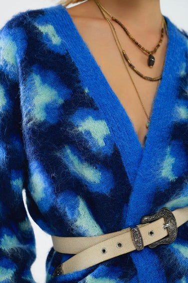 Close-up of Wave Cardigan in vibrant blue mohair knit with abstract pattern and soft texture