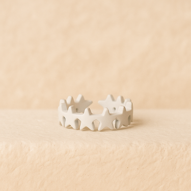 White enamel star ring on a beige background – Stars Adjustable Ring by Matte