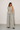 Woman wearing the Wilkin Set in a soft sage linen-blend fabric, featuring a tailored sleeveless vest, high-waisted wide-leg pants, relaxed fit, breathable woven texture, and an effortlessly elegant silhouette.