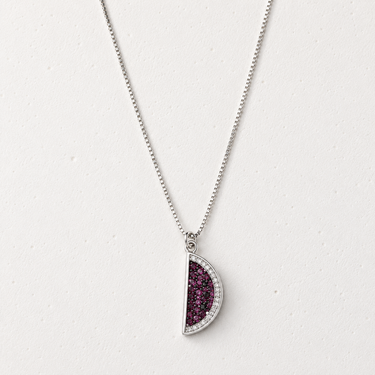 Zaromi Necklace featuring a silver-tone chain with a reversible half-moon pendant showcasing sparkling cubic zirconia on one side and vibrant pavé stones on the other, styled on a light neutral background for everyday layering.