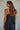 Zia Top rear view in black showing soft drape and flowing silhouette.