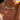 Matte Layering Necklaces Collection image featuring a close-up of a model wearing three layered gold necklaces, including a sleek herringbone chain and delicate fine chains, styled in warm golden light.