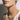Matte All Jewelry collection image featuring a close-up of a model wearing a gold clover pendant necklace on a delicate chain, styled with a white tank top in warm natural light.