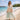 Woman wearing a lightweight resort coverup dress from the All Resort collection, styled outdoors in warm natural light