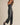 Model wearing the Melina strapless jumpsuit with relaxed straight-leg silhouette, side view.
