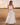 Matte All Bottoms collection image – model wearing a white cropped tank top with a flowing white maxi skirt in a golden sunset field