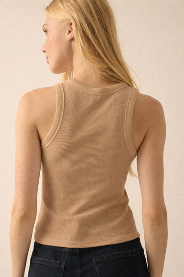 Abar Top back view showing fitted ribbed fabric and sleeveless cut, styled with dark denim for clean minimal everyday outfit.