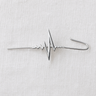 Silver heartbeat ear climber cuff with modern sculptural design displayed on light fabric background, Abeni Ear Climber Cuff by Matte.