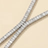 Adele necklace in silver featuring emerald-cut baguette stones in a refined tennis-style setting on a neutral background.