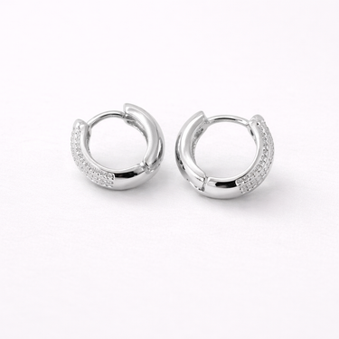 Agata Huggie Earrings silver version pair displayed on neutral background highlighting polished finish and continuous row of crystal stones