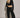 Woman wearing black Akima cropped velvet jacket with matching pants, full look front view.