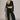 Woman wearing black Akima cropped velvet jacket with matching pants, full look front view.