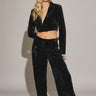 Woman wearing black Akima cropped velvet jacket with matching pants, full look front view.