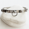 Alaia Bangle Bracelet — silver bangle bracelet with pyramid studs and ring detail on white linen background, polished and bold jewelry by Matte.