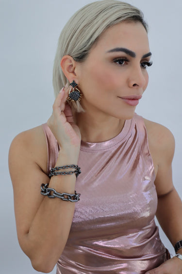 Model wearing the Alameda Sleeveless Top — rose gold metallic high-neck sleeveless blouse, close up.