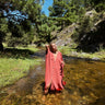 Alba Cover Up lightweight coral maxi cover up dress worn in shallow river natural outdoor setting full length front view