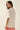 Alina Tee back view showing oversized relaxed silhouette and soft drape, cream t-shirt with clean back design and loose casual fit on model.