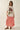 Alina Tee oversized cream floral graphic t-shirt styled with a long red skirt, showcasing relaxed fit and statement print for an artsy effortless outfit.