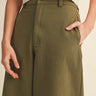 Altea Pant – relaxed wide-leg pants in olive cotton with high-rise waist, front view on model.