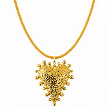 Amaita Necklace close-up of gold heart pendant necklace with sculpted textured finish and polished shine on neutral background.