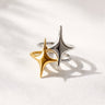 Gold and silver star shaped statement rings with polished metal finish on neutral background.
