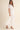 Amirkat Set white two-piece outfit with cropped lace top and flowy midi skirt front full body view on model wearing sandals in neutral studio setting