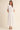 Amirkat Set white outfit styled with flat sandals creating effortless resort wear look