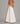 Side view of the Annalise Wide Leg Palazzo Jeans in white with a high-rise fit, dramatic wide-leg silhouette, structured denim fabric, classic front pockets, and oversized palazzo shape.