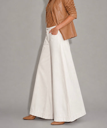 Side view of the Annalise Wide Leg Palazzo Jeans in white with a high-rise fit, dramatic wide-leg silhouette, structured denim fabric, classic front pockets, and oversized palazzo shape.