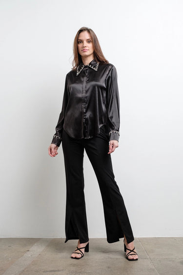 Front view of Astra Crystal Blouse in black satin, crystal-embellished collar and cuffs, worn with slit-hem black pants.
