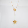 Astra gold-tone star pendant necklace by Matte displayed on white surface
