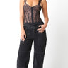 Atta Bodysuit full body look featuring black lace corset bodysuit paired with black jeans, showing flattering structured fit and lingerie-inspired detailing designed for parties and after-dark styling.